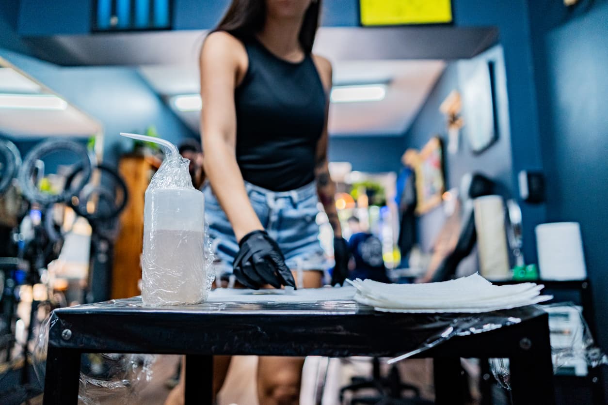 Shop owner at the counter checking a packing slip against an open delivery box